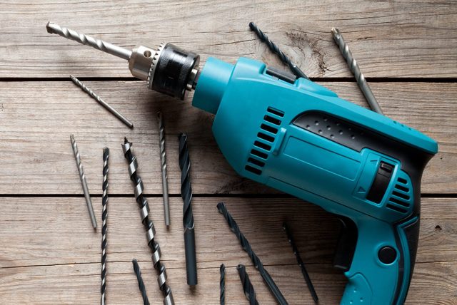 Electric drill on old wooden table