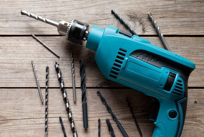 Electric drill on old wooden table