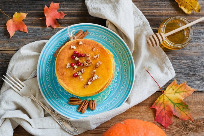 Homemade pumpkin pancakes with pecan nuts and honey