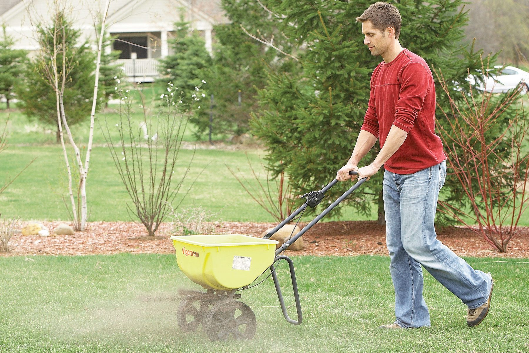 A person Applying Soil Activator on the grass field