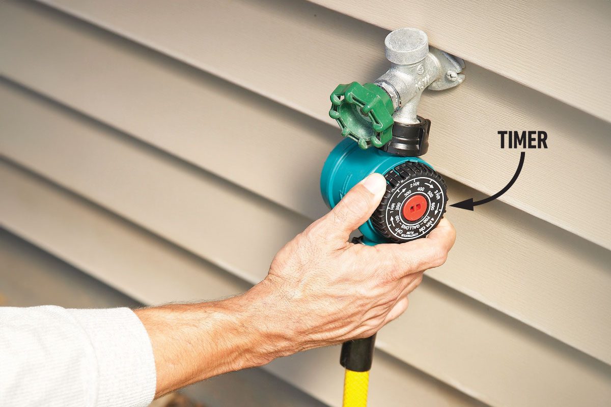 A person setting the timer on water tap