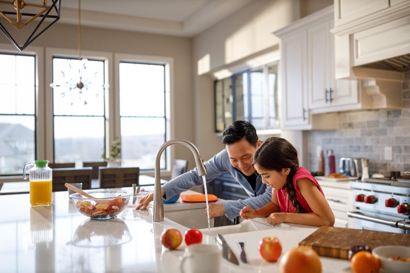 Father and daughter marveling at their sink