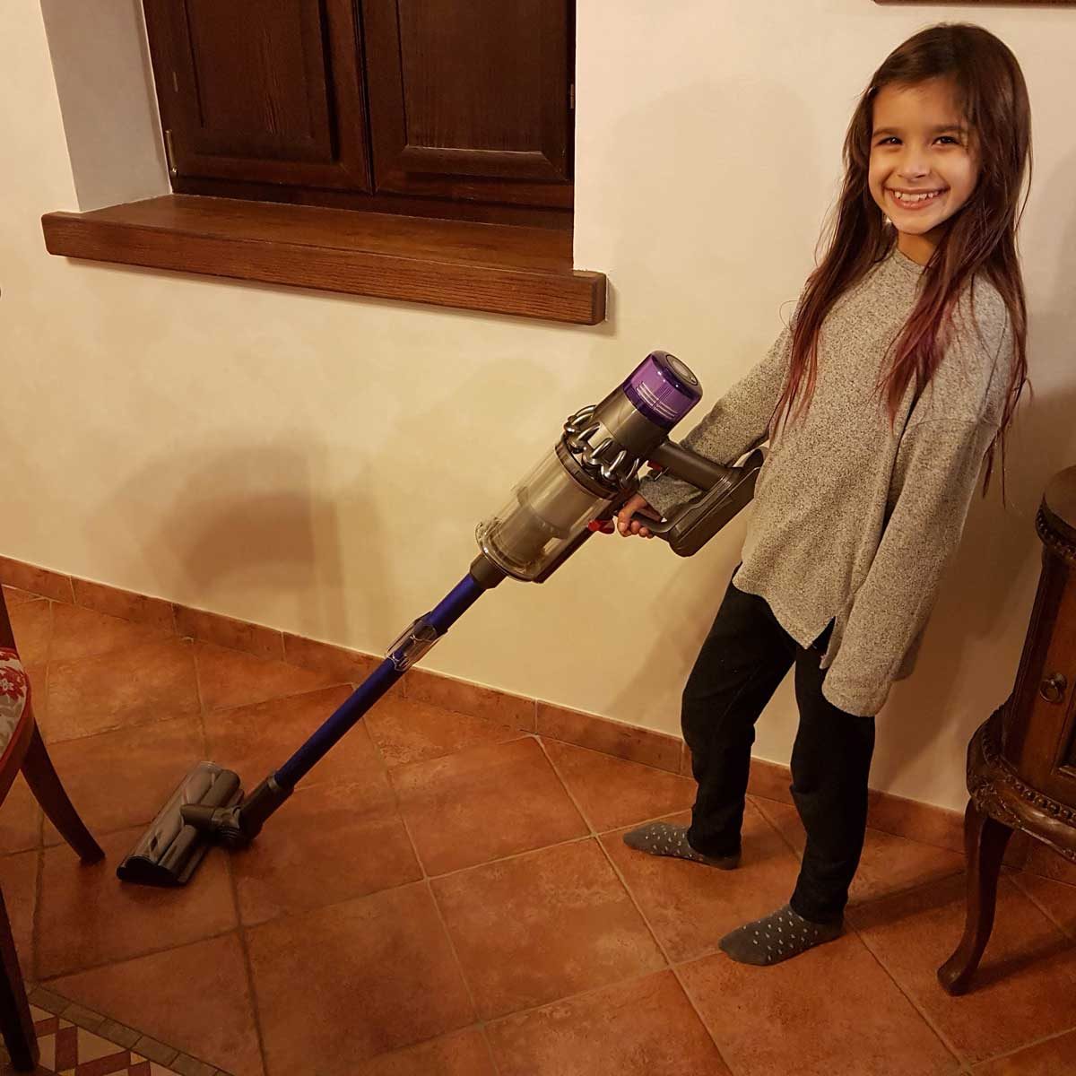 Girl using a Dyson vacuum