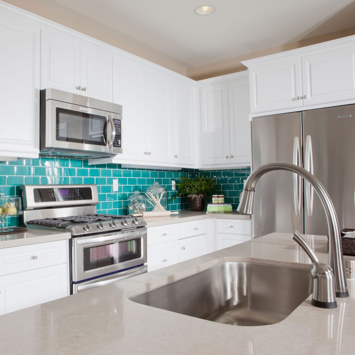 Small kitchen with a blue backsplash