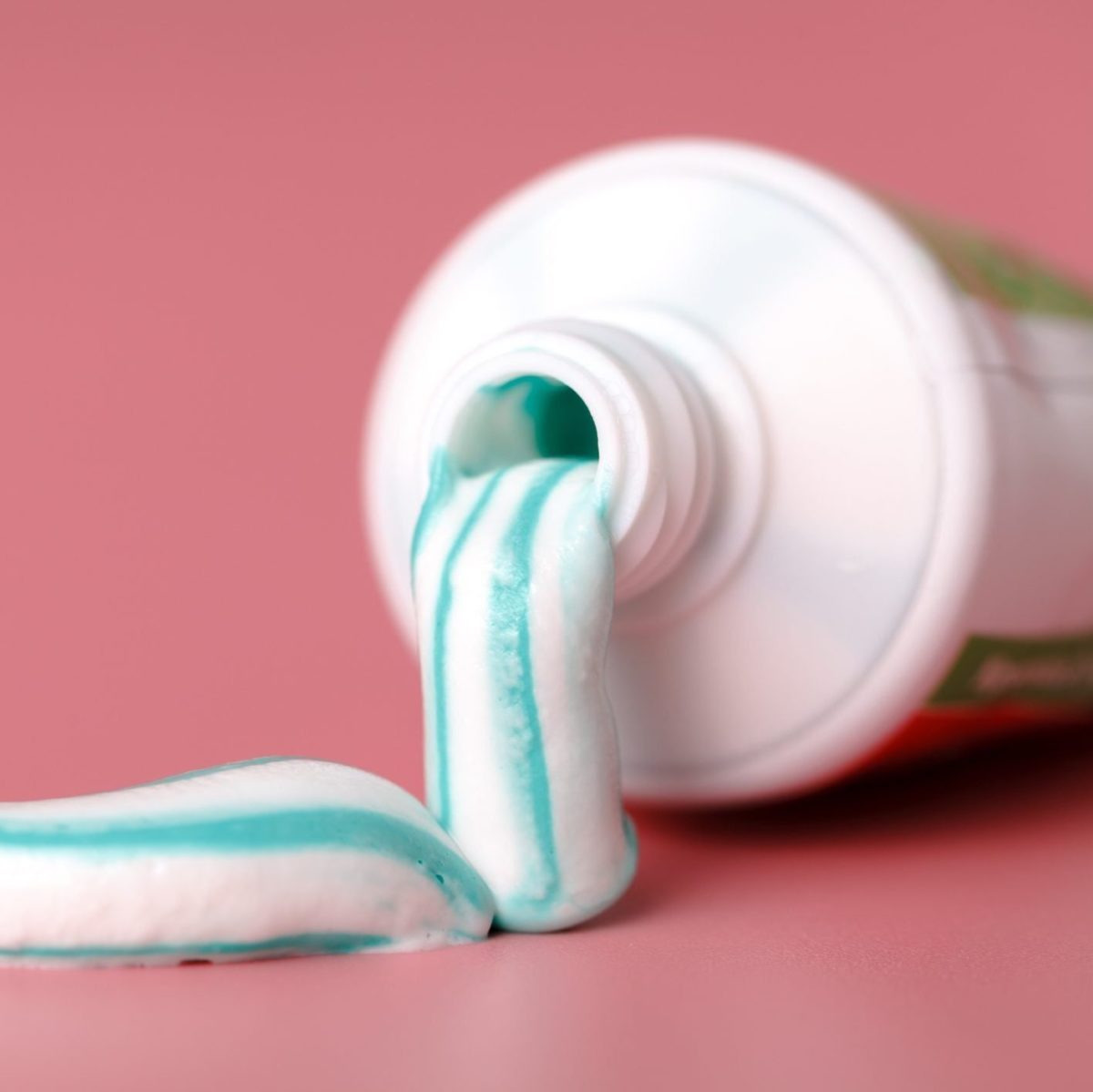 Tooth paste close up on pink background