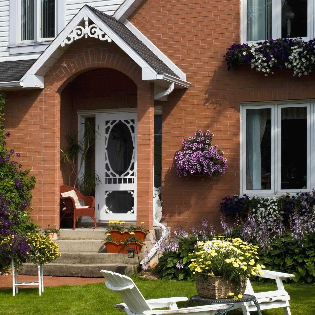 House with window boxes, wall-mounted boxes and front step flower boxes