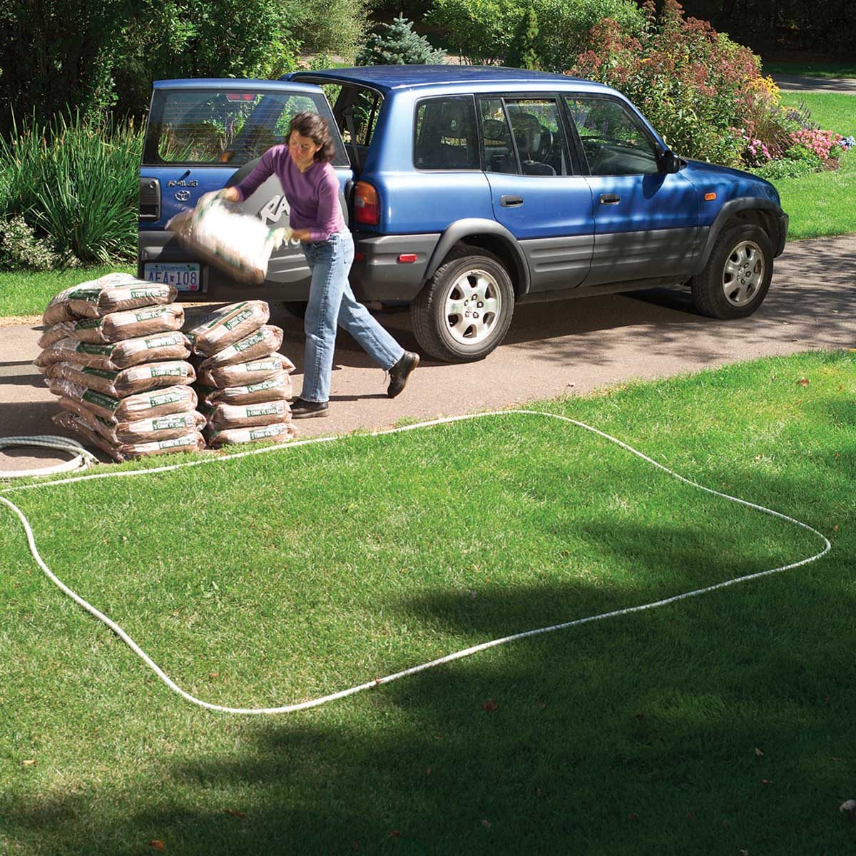 Removing mulch bags from vehicle