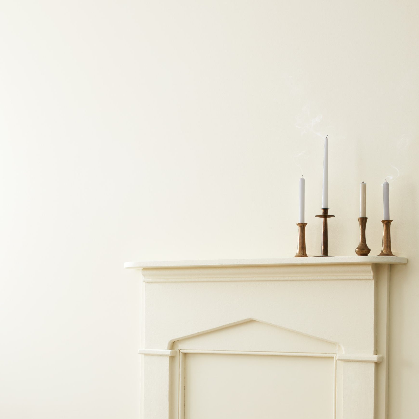 White Painted walls with candle sticks on a matching fireplace mantle