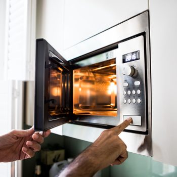close up of using a microwave at home