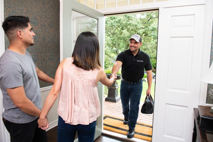 American Standard Company Representative Shakes Hands With Clients As They Greet Him