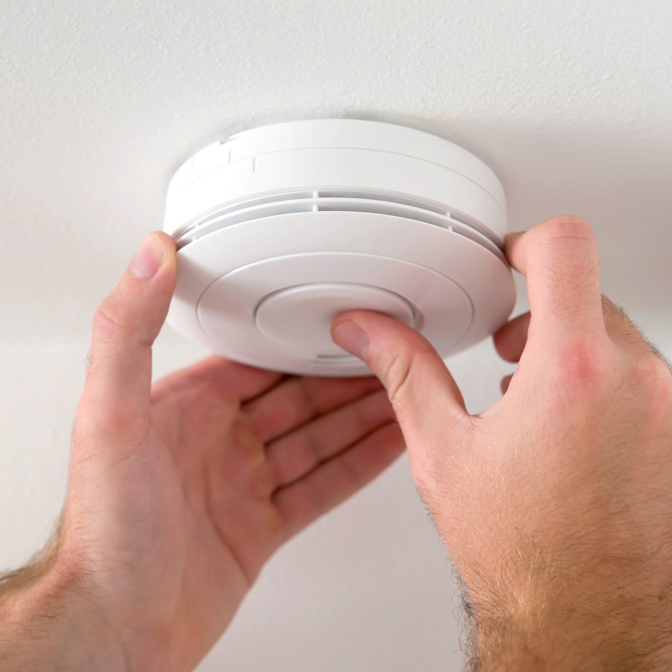 Man installing smoke detector