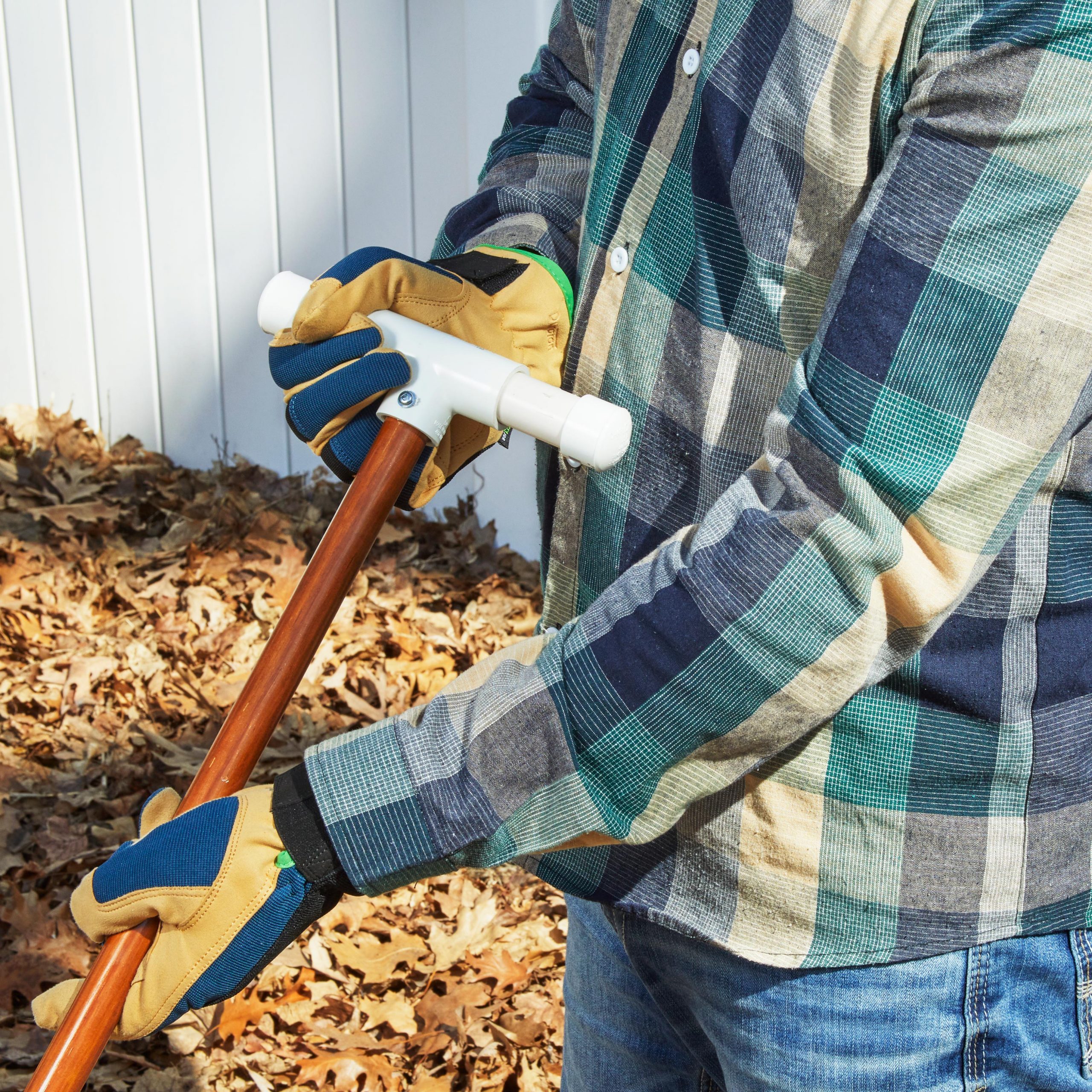 holding rake with PVC pipe attached to the ends