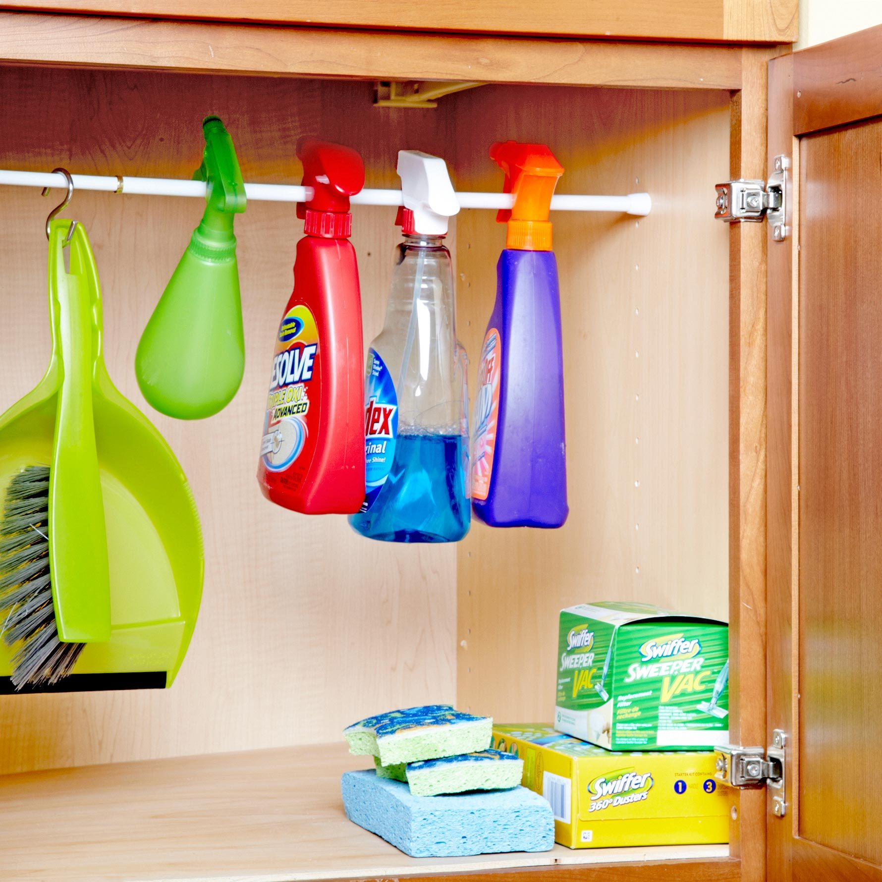 curtain rod inside a cabinet for hanging cleaning supplies