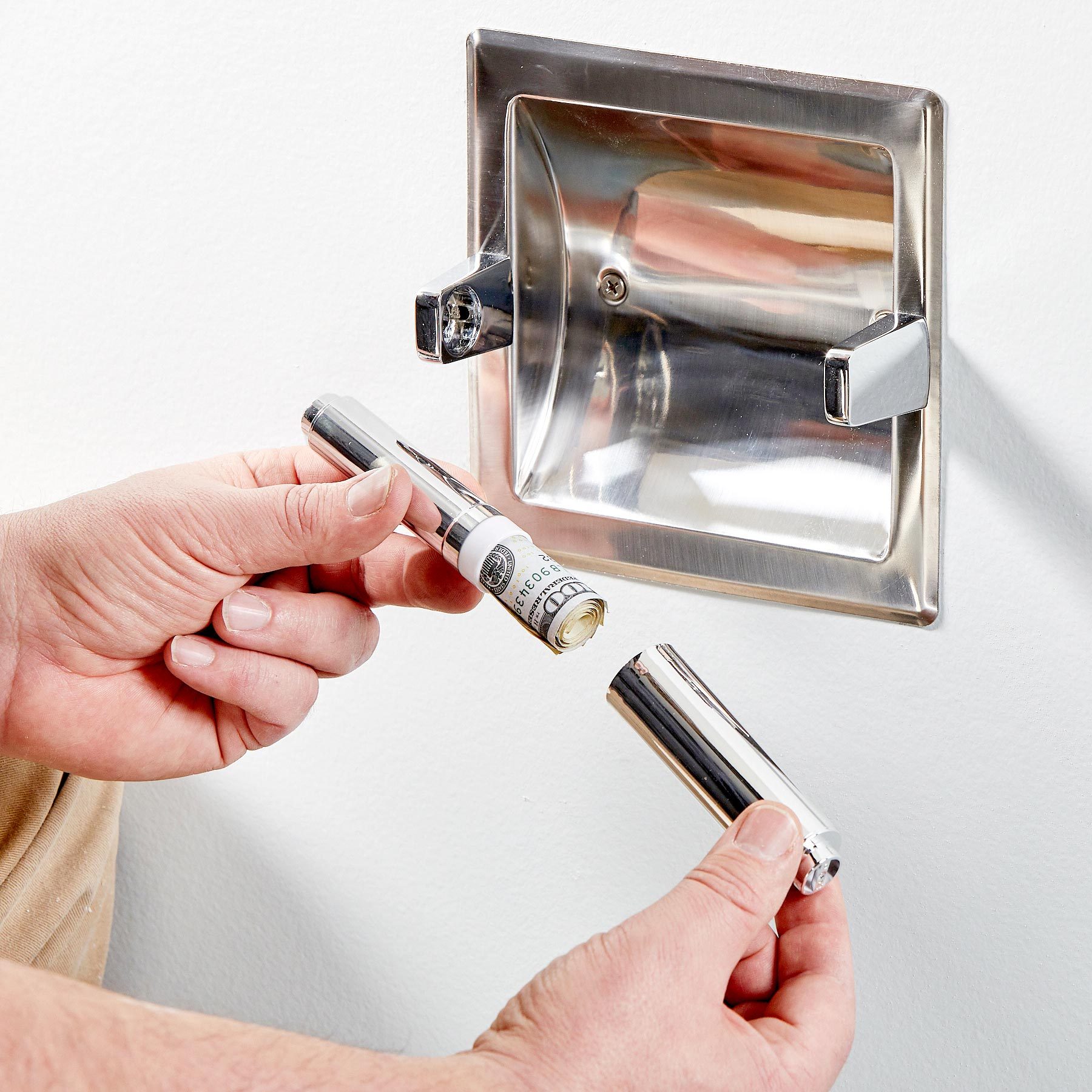 hiding rolled up money in a toilet paper roll holder