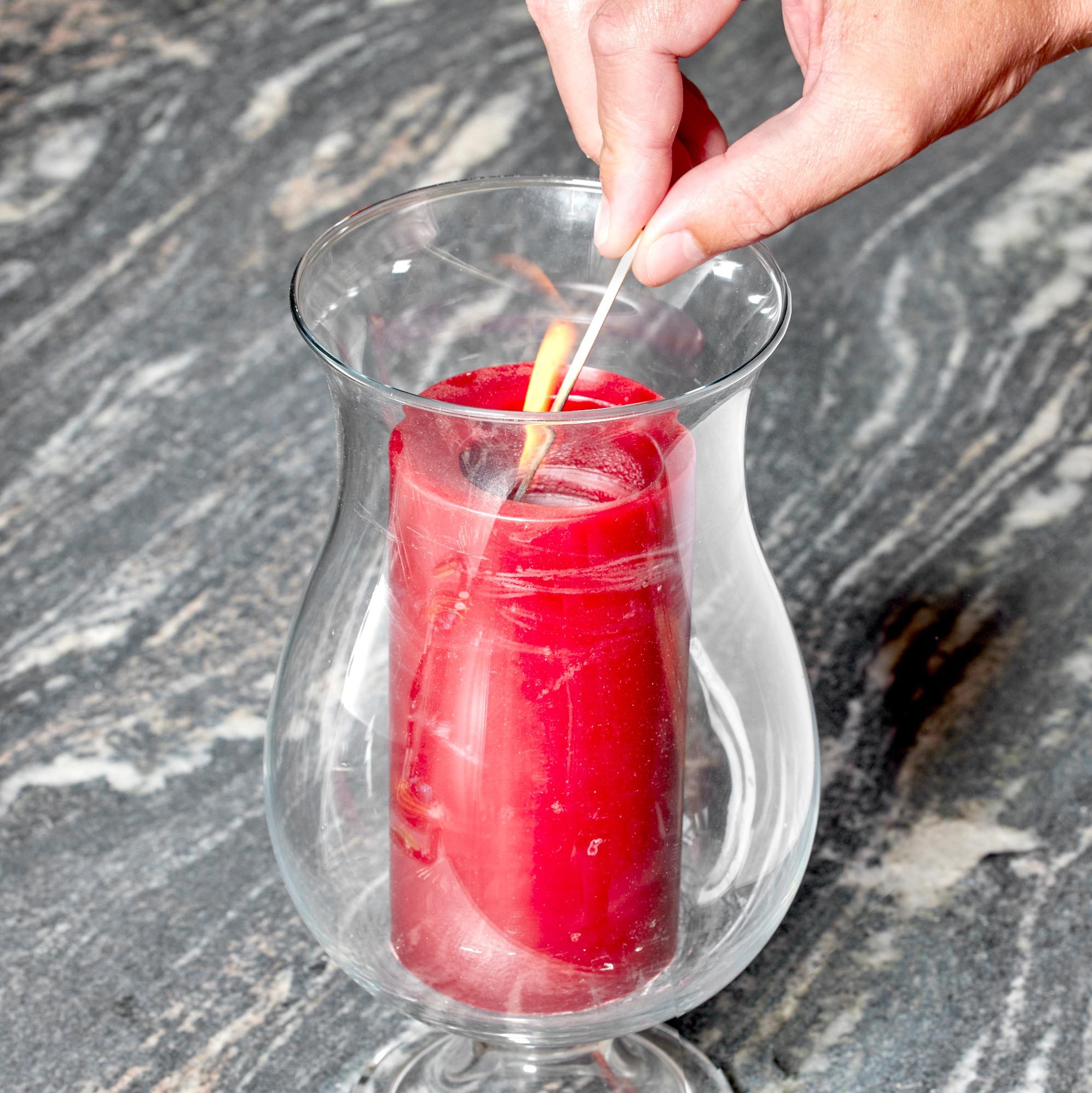 lighting a candle in a jar with a toothpick
