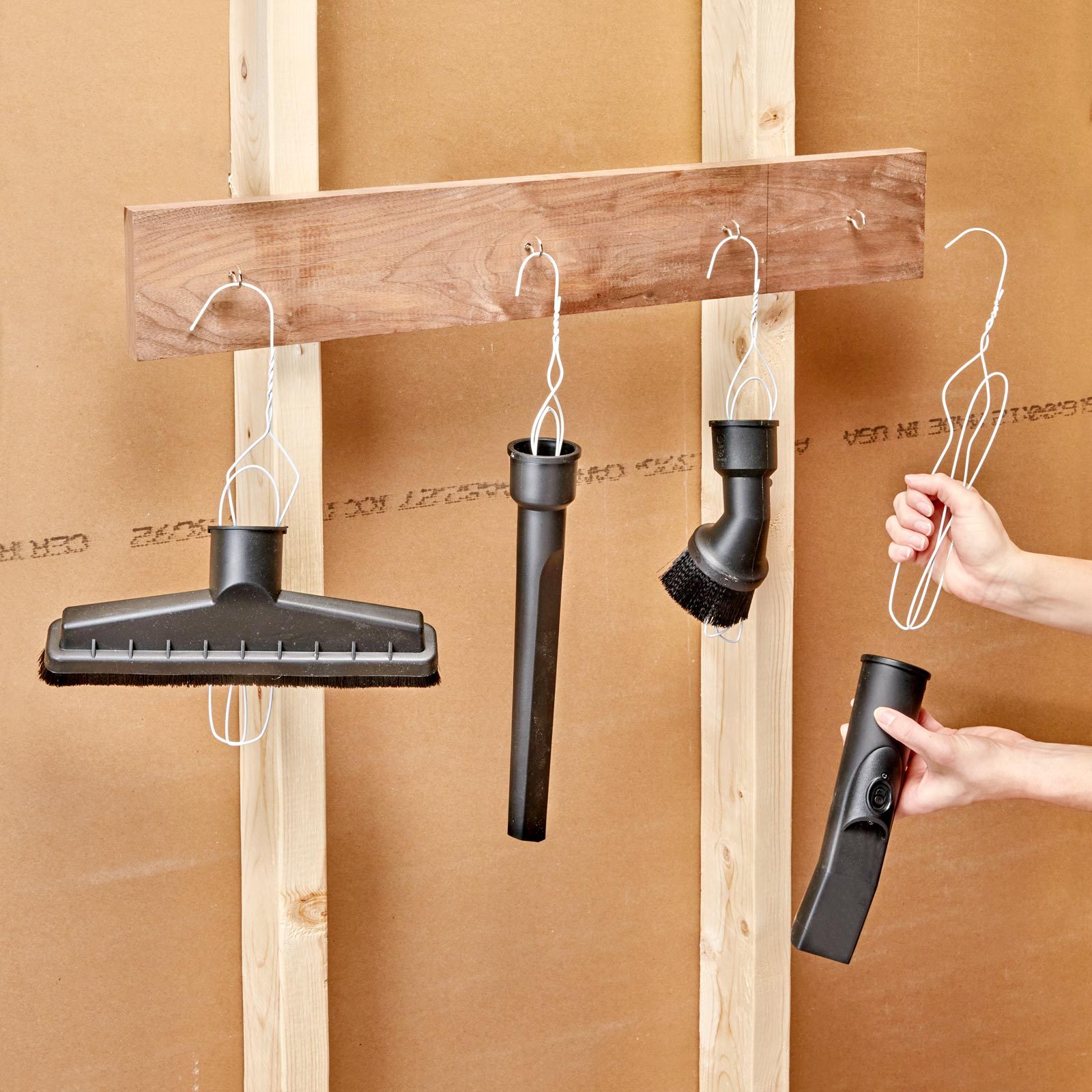 metal hanger organizer in garage for hanging vacuum attachments