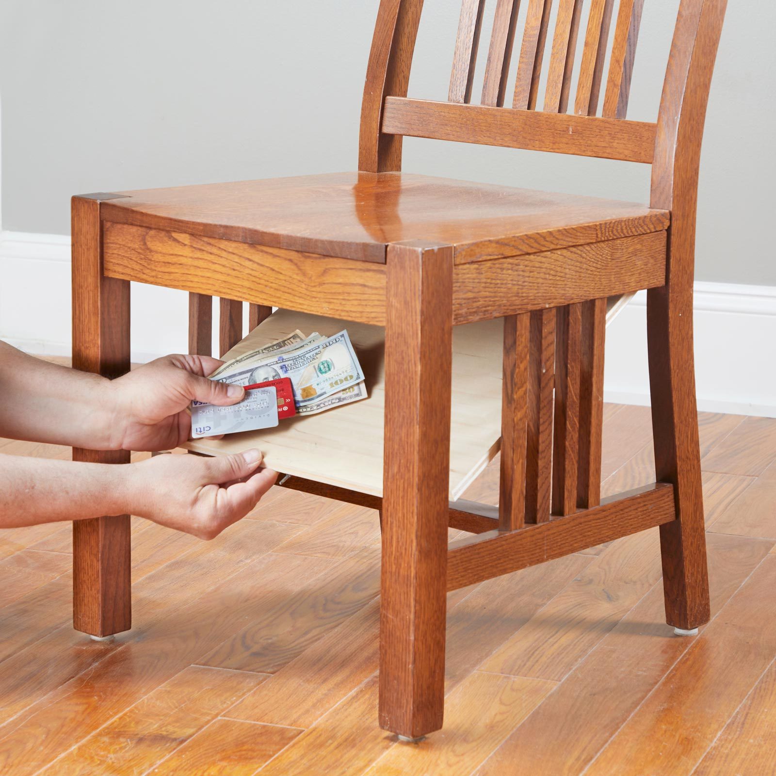 hiding money and important documents under a wooden chair