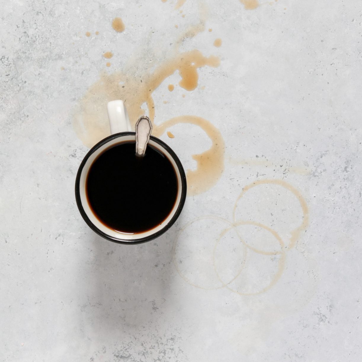 Coffee Cup with coffee ring stains on a white kitchen counter