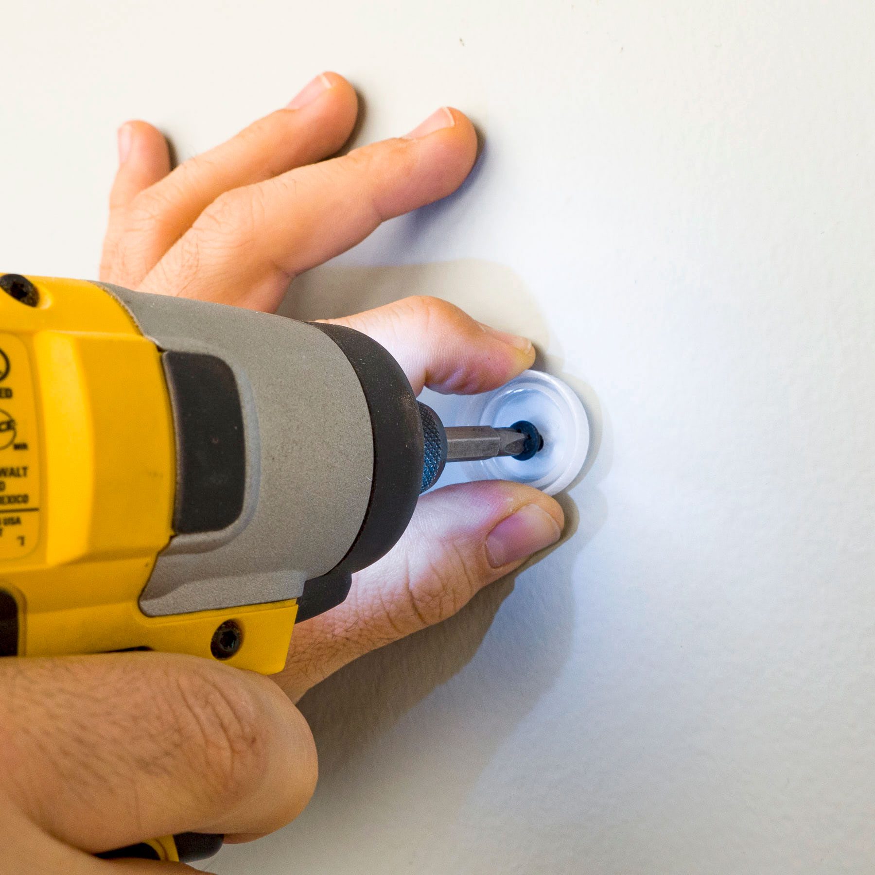 person using a bottle cap to drill a hole