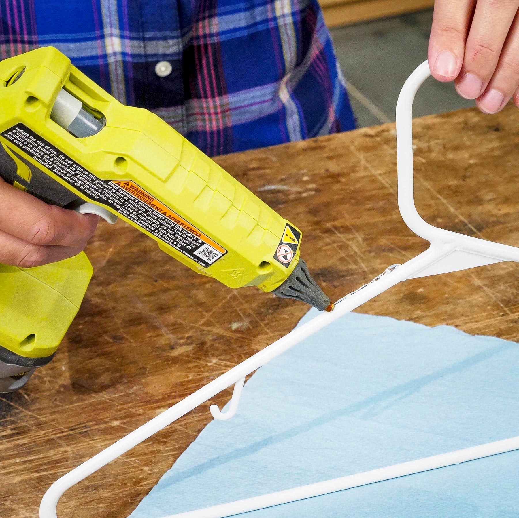 using a hot glue gun to line a clothes hanger