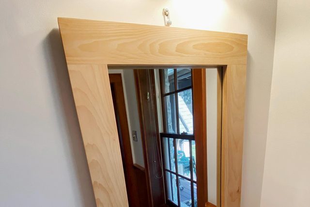 hanging the mirror frame in the bathroom above the sink