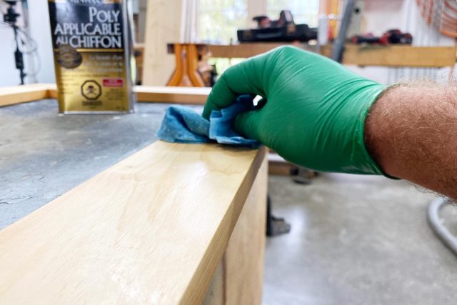 applying finish to the wooden mirror frame