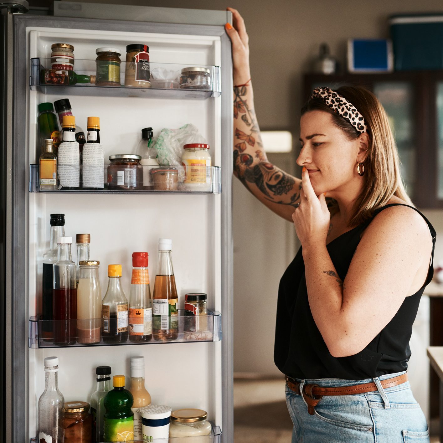 Shot of a young woman searching inside a refrigerator at home