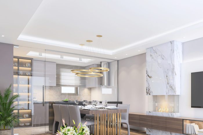 Sparse and modern home interior with fireplace and isolated kitchen