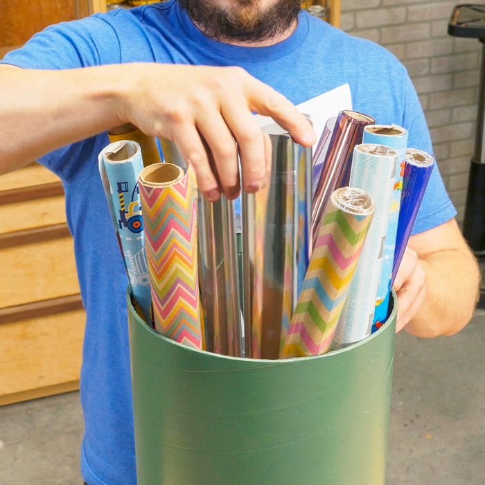 holding wrapping paper in a recycled concrete tube