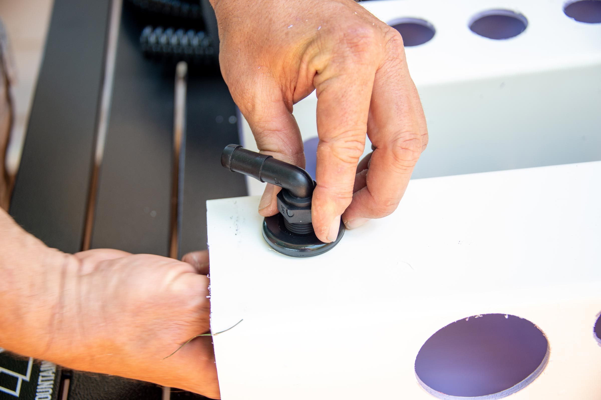 inserting the elbow into the bulk head fitting
