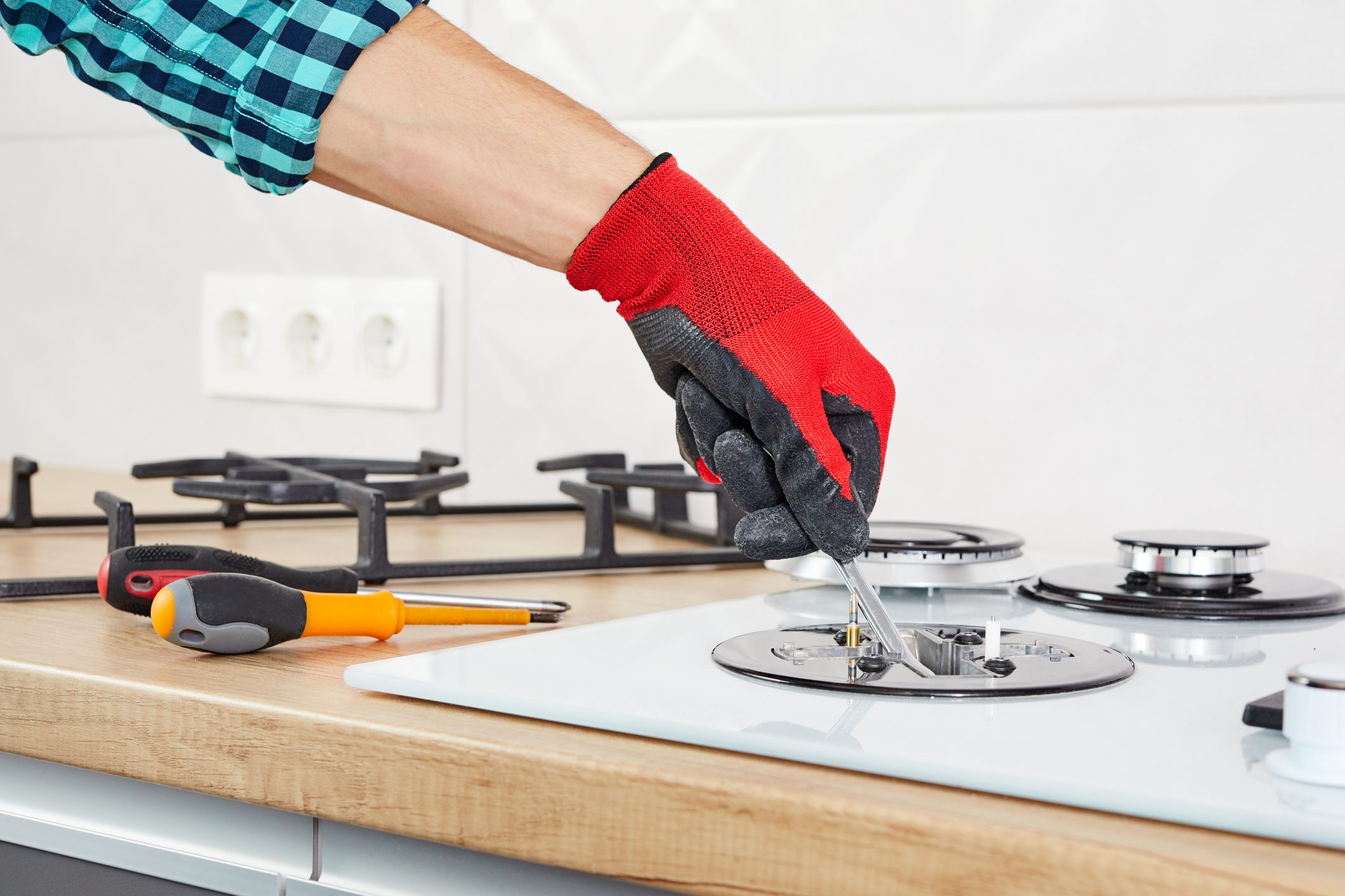 repair man fixing a stove