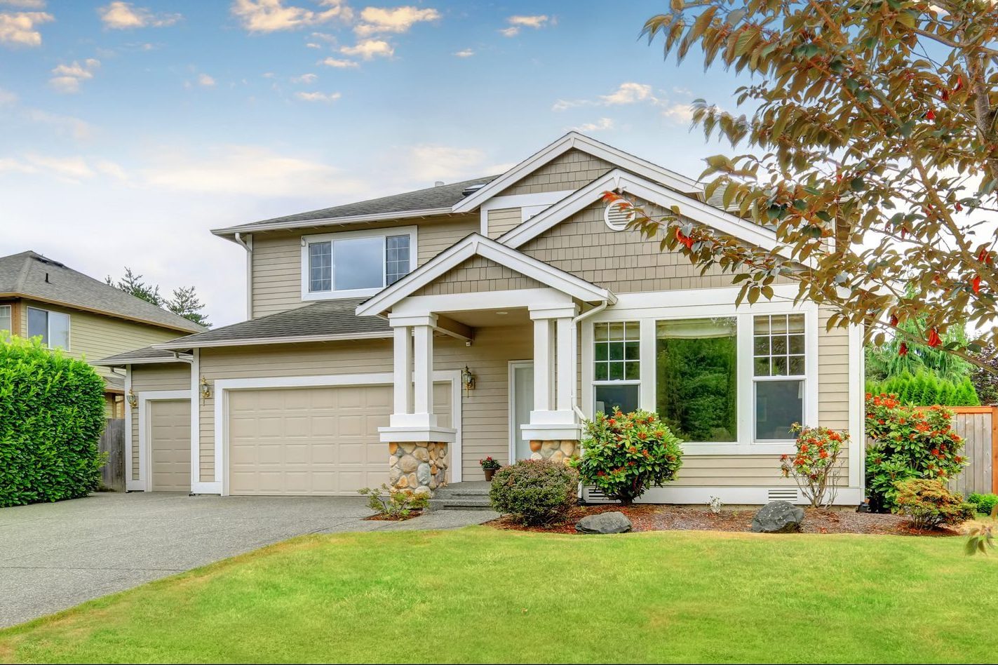 Neat beige home with two garage spaces.