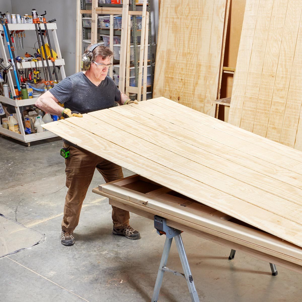 man in a workshop making the exterior coverings for the sauna walls