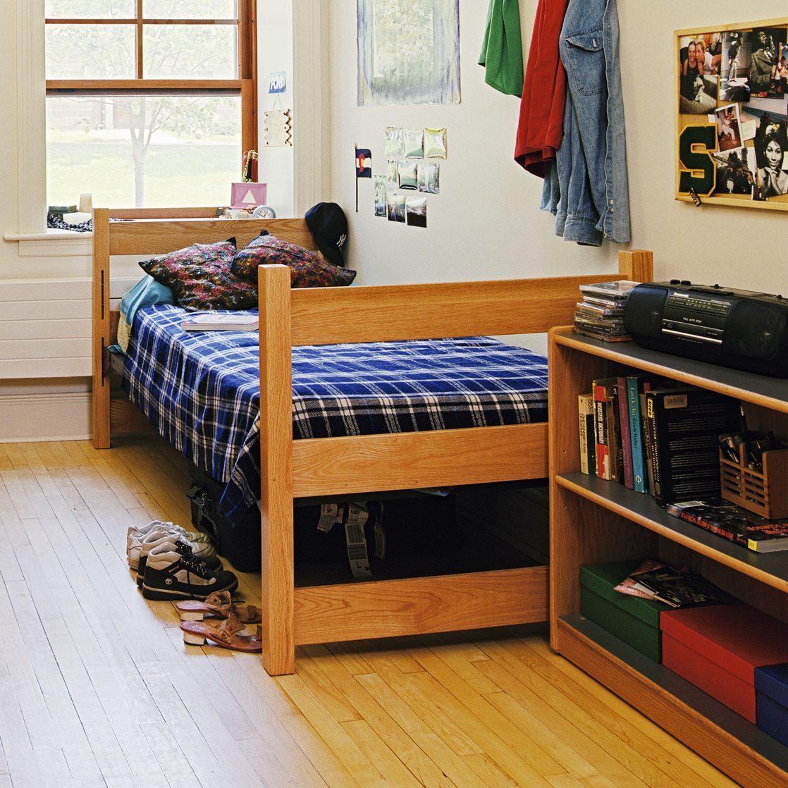 Dorm Room with Brick Fireplace and Wood Floor