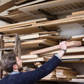 Gettyimages 960907540 Rear View Of Carpenter Working At Workshop By Cavan Images