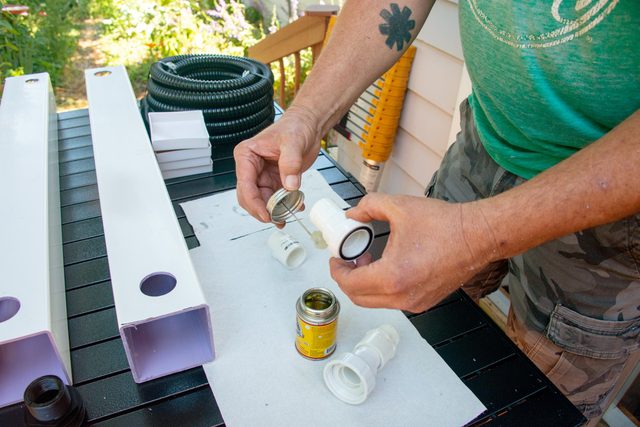 glueing together the union fittings with rubber cement