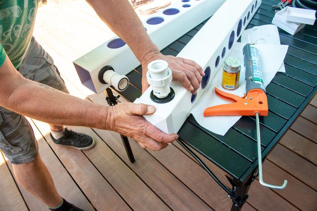 pushing on the end cap in place and holding so the sealant adheres