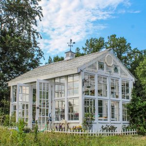 Beautiful Victorian style greenhouse with cupola and weathervane