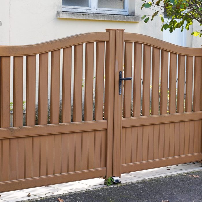 classic brown street home door aluminum gate slats portal of suburb house