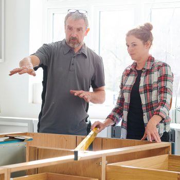 Homeowner And Contractor talking In A Kitchen Remodel