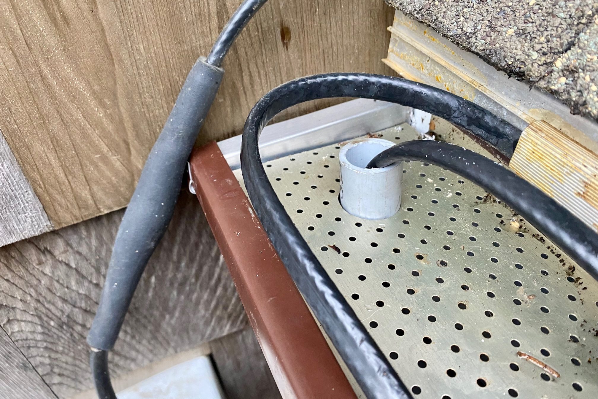 Route heating cable through downspout