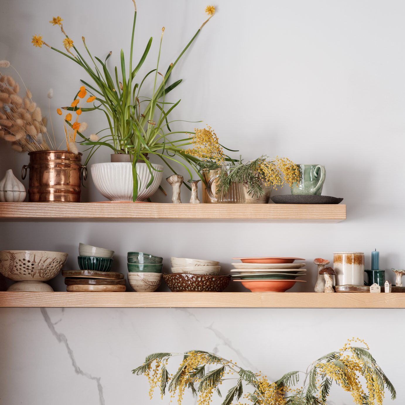 Kitchen Shelves With Ceramic Utensils, Fresh Flowers And Ceramic Figures Of Mushrooms And Beetles