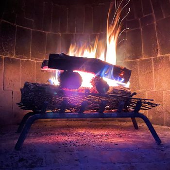 logs burning in wood fireplace