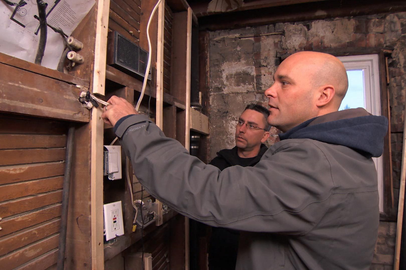 a man helping with renovations in an old home