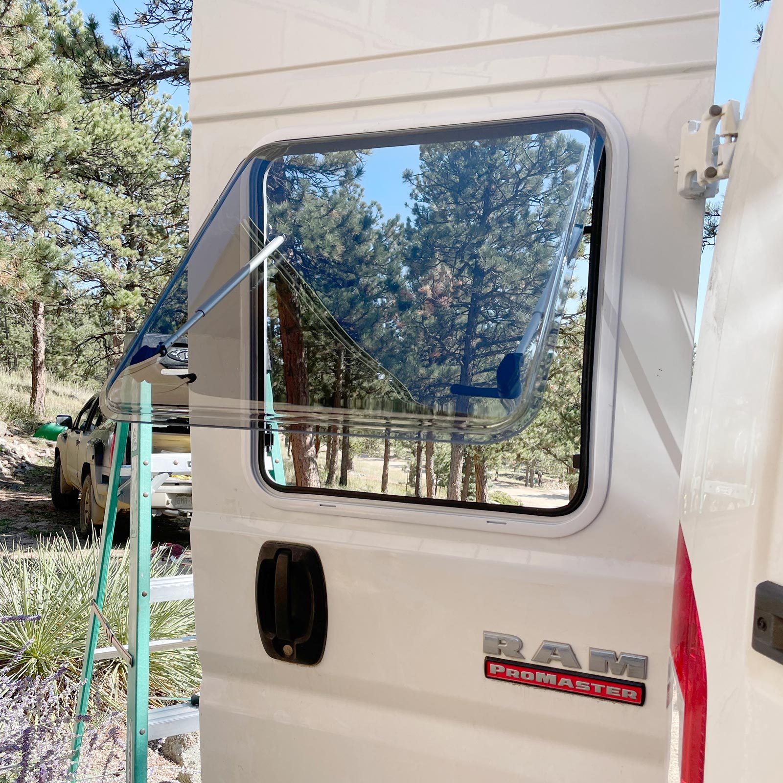 close up of a new window installed in a white camper van door