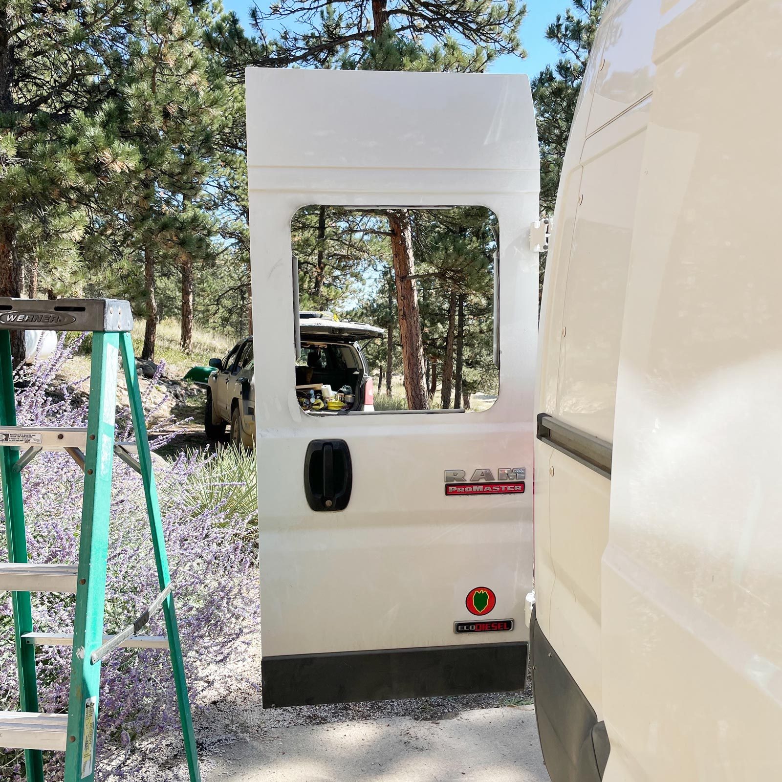 cutting a whole for a new window in a white van door