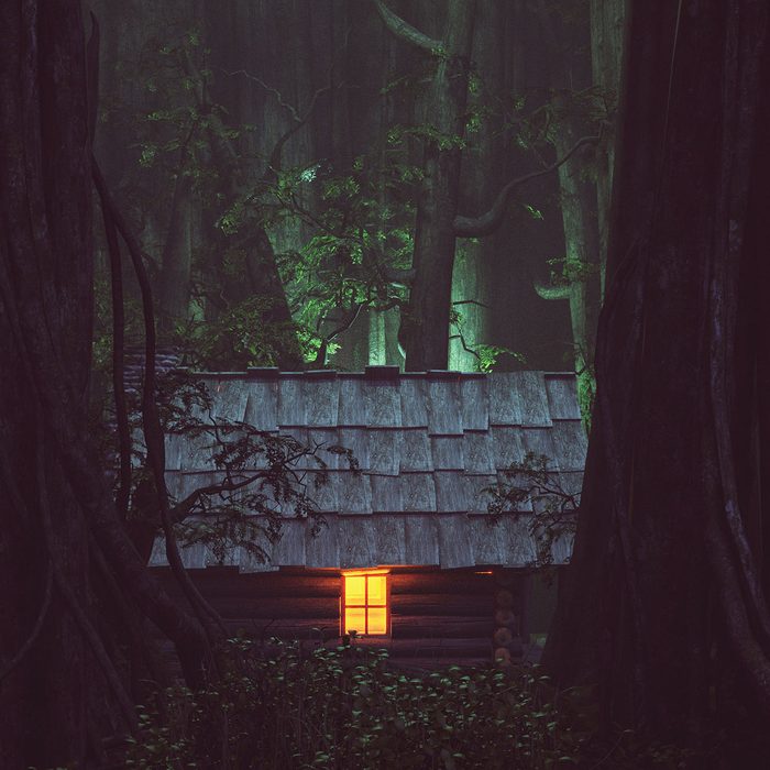 Light From Window Of An Old Cabin In Haunted Forest