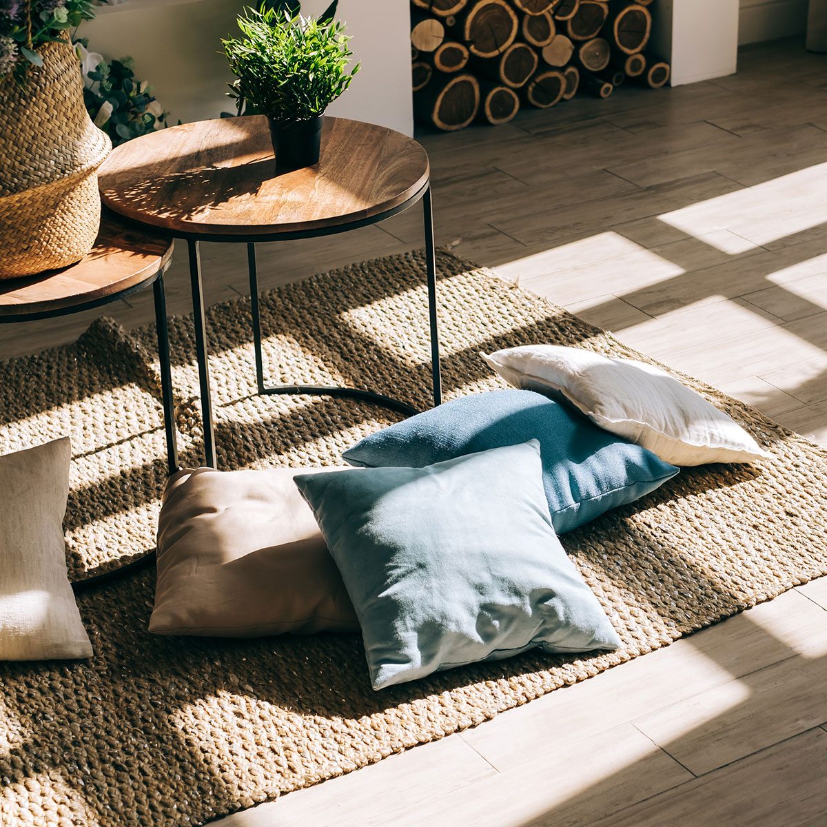 Interior Of Bright Living Room In Scandinavian Style With Coffee Table And Pillows On The Floor