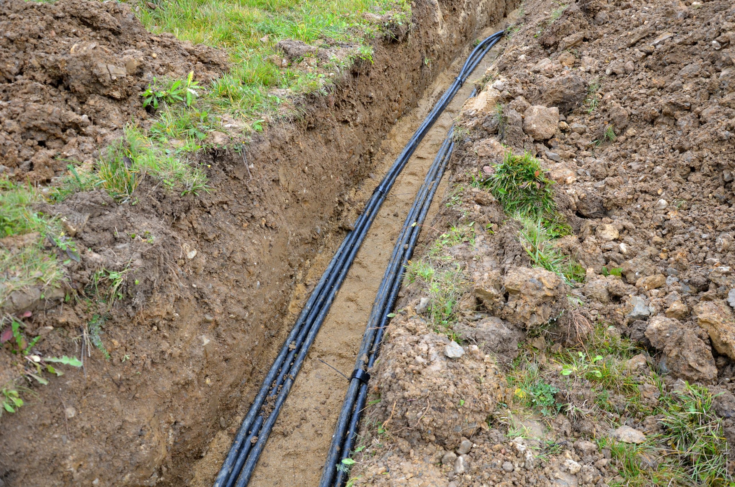 laying high voltage cables to the ground. the environment does not damage electric poles. Excavation meter deep in the ground black plastic coated strong cable wires. risk of electric shock in case of insulation failure. cover with sand and plastic protec