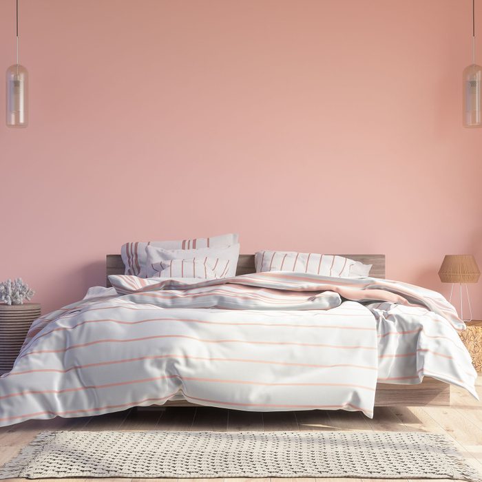 Bedroom Interior With Messy Bed, Pendant Lights, Parquet Floor And Pink Color Wall Background